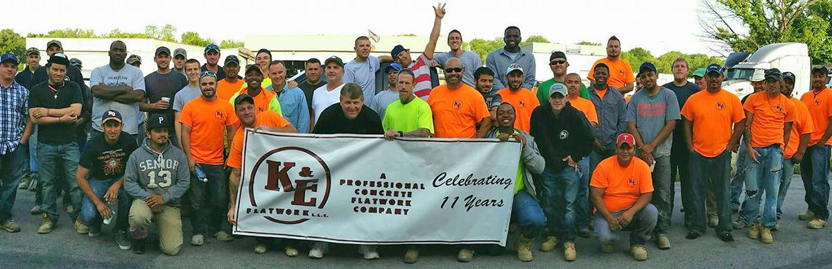 Ke Flatwork Company Photo While Holding Banner Ke flatwork company photo while holding banner