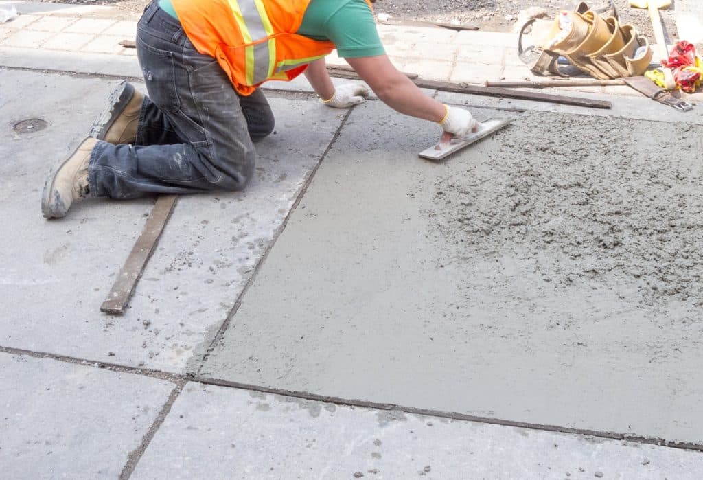 Construction worker paving the concrete