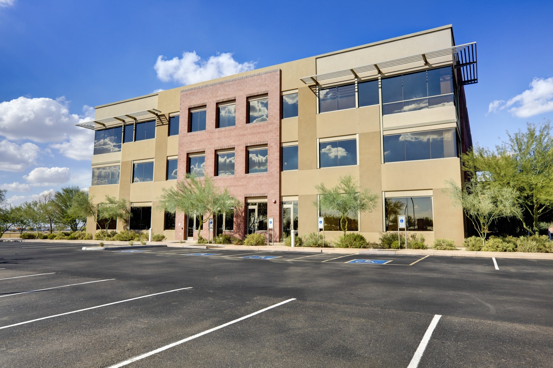 This is a picture of an office building and well-maintained parking lot.