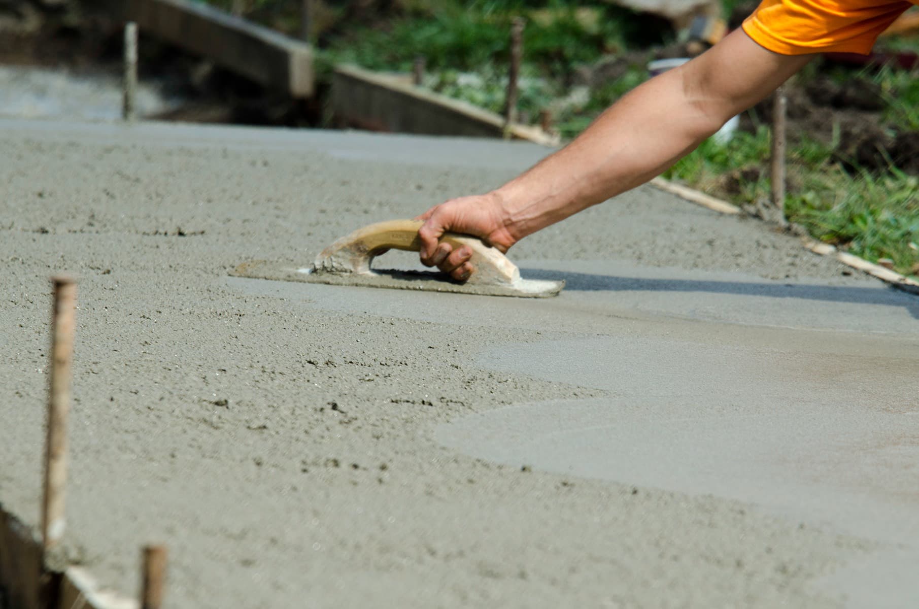 A man screeding concrete